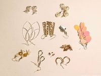 Overview of 12 assorted earrings showing variety of metals, styles, and colors taken front and top down.