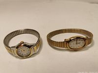 View of the two Timex ladies watches with metal expansion bands, showing the face and band details.
