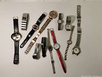 Full view of the Lot including 12 watches with different styles and bands laid flat in two rows