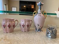 Photo showing all five pieces: two pink floral mugs, 9-inch decorative vase with gold handles, small matching dish, and Seagull pewter piece.