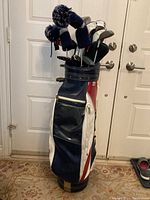 Golf bag standing upright showing front and side with Hurricane branding and handle