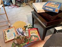 Full lot view showing various puzzles, puzzle trays, styling brush, floral decor, and mats