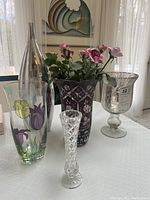 Group photo of all five vases on table with window background