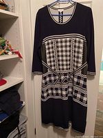 Full view of the Escada Sport ladies dress hanging on a hanger, showing the front pattern and length.