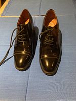 Front view of pair of new black lace-up shoes with rounded toe and laces, size 7.5.