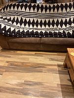 Comforter laid out showing full black and tan geometric pattern with triangles