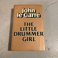 Front cover of the hardcover book showing title and author name on tan/orange dust jacket.