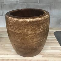 Front side view of the vintage wooden bowl showing rounded cylindrical shape and textured wood grain surface.