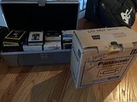 Open hard case showing multiple eight-track tape cartridges