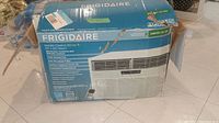 Boxed Frigidaire room air conditioner unit showing front packaging with product image and branding.
