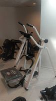 Full view of the Weslo Air Strider elliptical trainer showing white frame, two moving handlebars, and foot pedals.