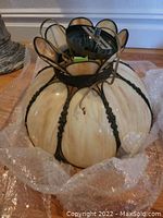 Photo of Tiffany style stained glass chandelier lamp showing full fixture wrapped in bubble wrap.