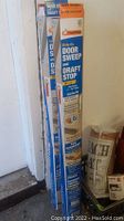 Three packages of Frost King Slide-On Door Sweeps for door draft stopping.