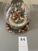 Top view showing the clear globe with the nativity scene of Mary, Joseph, baby Jesus, and animals inside. The globe is clear but missing water.