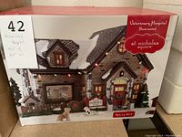 Boxed St. Nicholas Square Veterinary Hospital collectible with size label visible