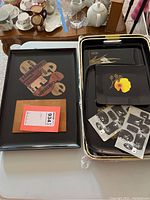 Set of smaller black lacquered serving platters with floral decoration and auction tag
