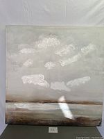 Full frontal view of the abstract painting print showing cloudy sky and horizon with muted neutral tones.