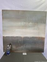 Full front view of the abstract print against a white backdrop. A water bottle placed next to it for scale.