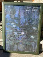 Frontal view of framed print showing water lilies artwork, Musee d'Orsay Paris and Claude Monet text in top right corner.