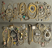 Overview photo showing a wide assortment of mixed vintage and new costume jewelry items including necklaces, bracelets, pins and earrings
