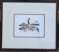 Full framed lithograph showing geese and a small bird in natural setting with cream-colored mat and dark wood frame.