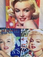 Set of 3 Marilyn Monroe prints showing colorful, pop-art style portraits of Marilyn Monroe with blonde hair and glamorous expressions, each square shaped.