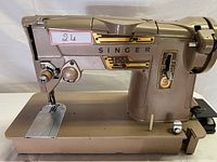 Full side view of vintage Singer sewing machine showing body and base with controls visible