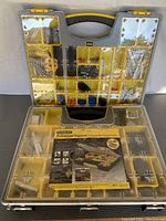 Two Stanley Professional Organizers, one open showing assorted metal hardware in 25 compartments, the other closed with packaging label visible.