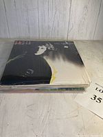 Stack of 11 vintage vinyl record albums showing the top one featuring Basia 'Time and Tide' album cover.