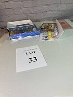 Photo showing the set of 6 acrylic paint tubes in a box alongside numbered paint pots and paint-by-number instruction sheet.