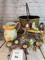 Full view showing the ceramic pitcher, nine fruit and vegetable shelf sitters arranged on a wooden stool, and a wicker handle basket.
