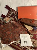 Photo showing the damask runner with a reddish-brown floral pattern, chain stitched wall hanging, and the hostess serving tray in its box.