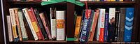 Books arranged on shelves showing various titles and subjects including medical guides, self-help and biographies