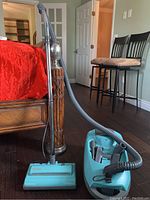 Full view of Kenmore Power-Mate vacuum cleaner with hose and wand assembled upright.