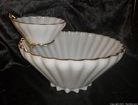Front side view of milk glass chip and dip set with gold trim on scalloped edges, black background