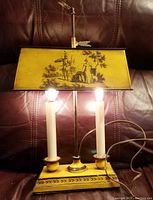 Front view of lamp illuminated showing dual bulbs and decorative shade