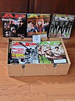 Photo showing five visible Alternative Press magazines with covers featuring Every Time I Die, Paramore, My Chemical Romance, Blood Lust Death, and Gym Class Heroes, packed in a box