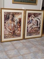 Two large professionally framed art prints by Brent Heighton titled 'Ancient Whispers' with classical figure themes and decorative borders.