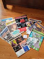 Overview photo showing 9 of the 15 Discoveries music magazines with visible covers including various artists and band photos.