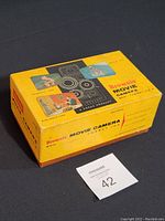 Original yellow Kodak Brownie Turret movie camera box showing vintage photos and branding.