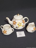 Sadler tea pot, sugar bowl, and creamer white ceramic with orange and yellow flower decoration and gold lid tip