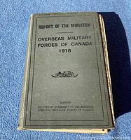 Front cover of the 1918 Overseas Military Forces of Canada report book showing title and emblem.