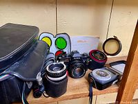Overview of entire camera kit on wooden shelf