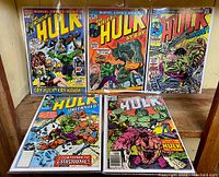 Photo showing five Marvel 'The Incredible Hulk' comic issues with vivid cover art and titles.