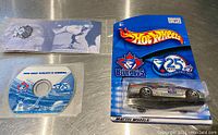 Blue Jays Hot Wheels car in mint on card packaging with coin and disc beside it