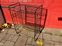 Front perspective view of stand showing two-tier wire shelves and casters