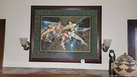 Front view of framed koi fish artwork on wall with sconces and decor
