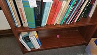 Full view of three shelves showing various medical textbooks including biochemistry, anatomy, orthopedics
