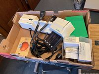 Box containing Welch Allyn diagnostic otoscope instrument with cable, and multiple accessory boxes
