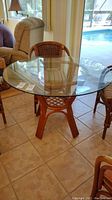 Glass and bamboo square table with clear removable glass top on bamboo base.